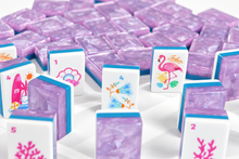 Standing Amethyst Garden American Mah Jongg tiles showing tropical illustrations and lavender marbled backs