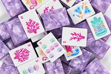 Scattered Amethyst Garden American Mah Jongg tiles showing floral faces and purple marbled backs
