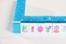 Azure Tropics American Mah Jongg tile wall with aqua backs and colorful tropical artwork
