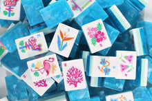 Azure Tropics American Mah Jongg flower and bird of paradise tiles over aqua marbled backs