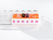 Coral Lotus American Mah Jongg lotus flower tiles on a clear rack with styling dice