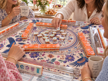 Coral Lotus American Mah Jongg tile set in play on a patterned table mat with friends