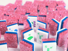 Standing Pink Stardust American Mah Jongg tiles showing sparkling pink backs and colorful faces