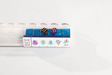 Sapphire Pavilion American Mah Jongg flower and Joker tiles on a clear rack with styling dice