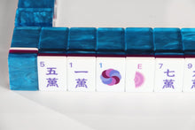Front view of Sapphire Pavilion American Mah Jongg character tiles beneath blue marbled backs