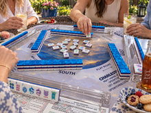 Sapphire Pavilion American Mah Jongg tile set in play on a blue table mat with friends
