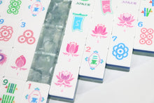 Close-up of Sea Glass Lotus American Mah Jongg illustrated faces and layered blue edges