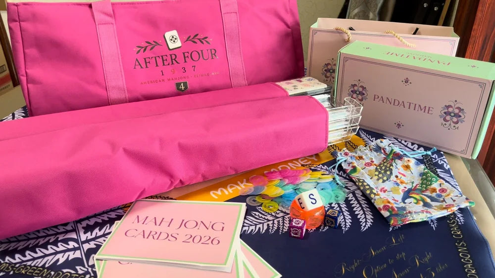 Pink AFTER FOUR carrying bag and sleeves, PANDATIME boxes, clear racks, dice, scoring chips and pouches on a patterned table mat