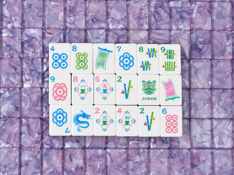 Eighteen face-up tiles showing dots, bamboo, characters, a dragon and a Joker on purple pearlescent tile backs