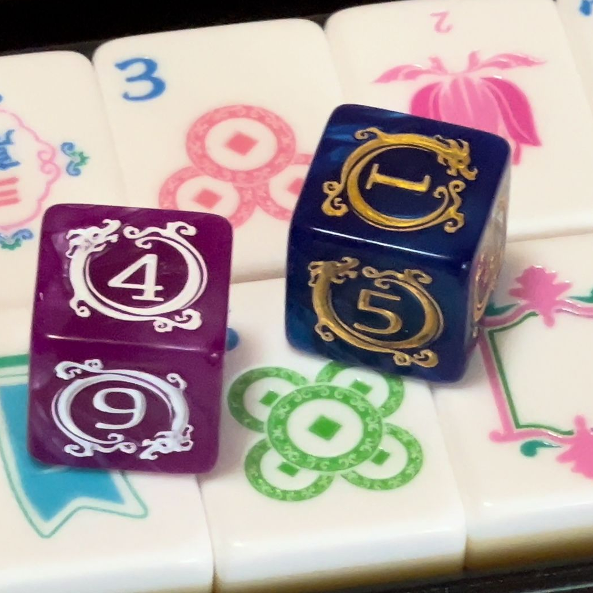 Two premium dragon dice in assorted purple and blue colors on real PANDATIME tiles