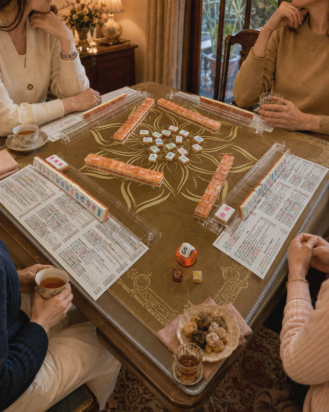 Four friends gathered around an AFTER FOUR American Mah Jongg table for a warm game night